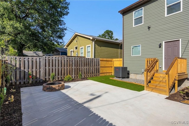 view of patio / terrace featuring central AC and a fire pit