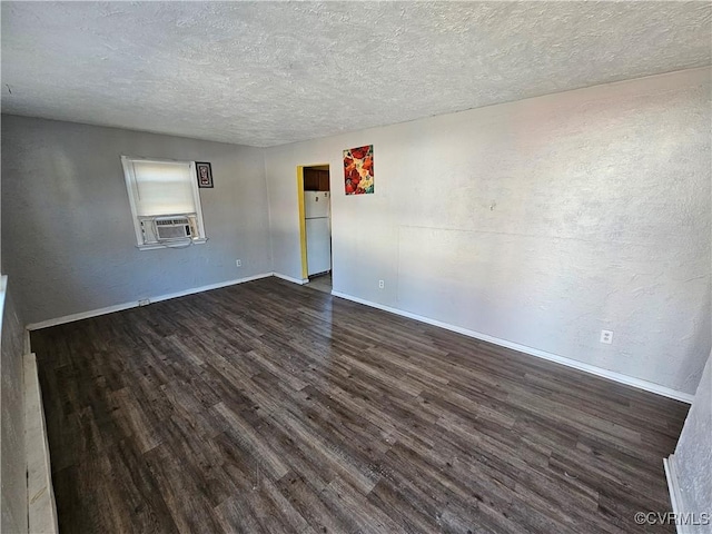 unfurnished room featuring a textured ceiling and dark hardwood / wood-style flooring