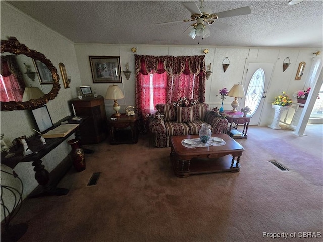 living room featuring carpet floors, a textured ceiling, and ceiling fan