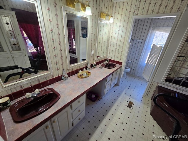 bathroom featuring toilet and vanity