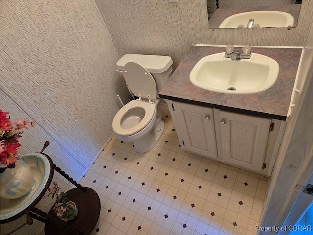 bathroom featuring toilet and vanity