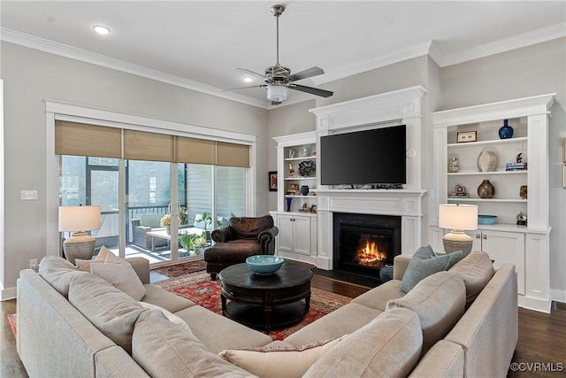 living room with dark wood-type flooring, ornamental molding, and ceiling fan