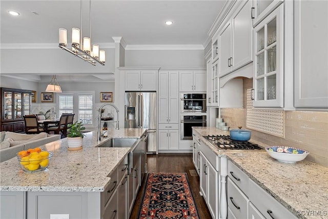 kitchen featuring an island with sink and white cabinets