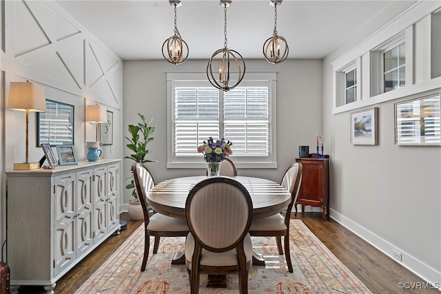 dining area with an inviting chandelier and dark hardwood / wood-style flooring