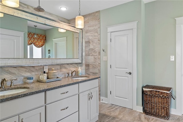 bathroom with tasteful backsplash and vanity