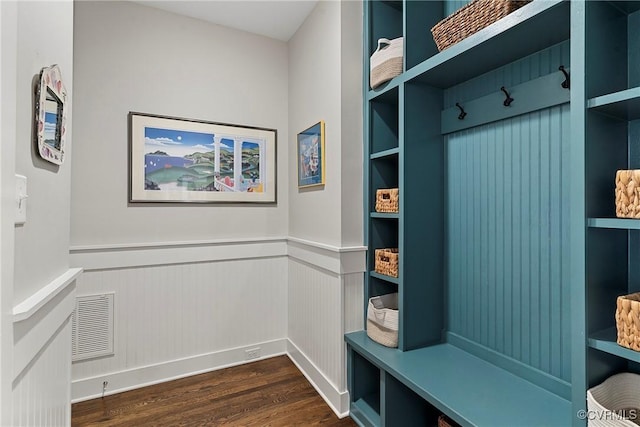 mudroom with dark hardwood / wood-style flooring and built in features