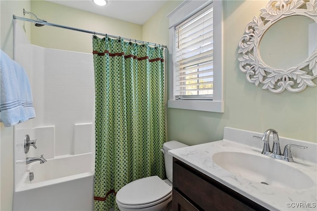 full bathroom featuring vanity, shower / tub combo with curtain, and toilet