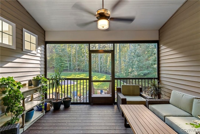 sunroom featuring lofted ceiling and ceiling fan