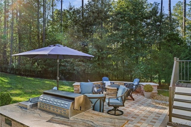 view of patio with grilling area, area for grilling, and a fire pit