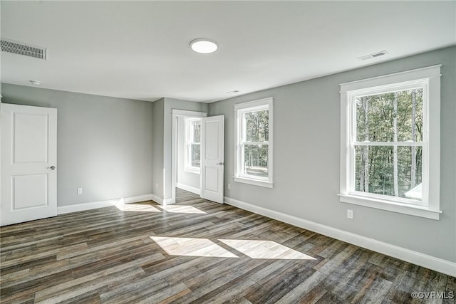 unfurnished room featuring dark wood-type flooring