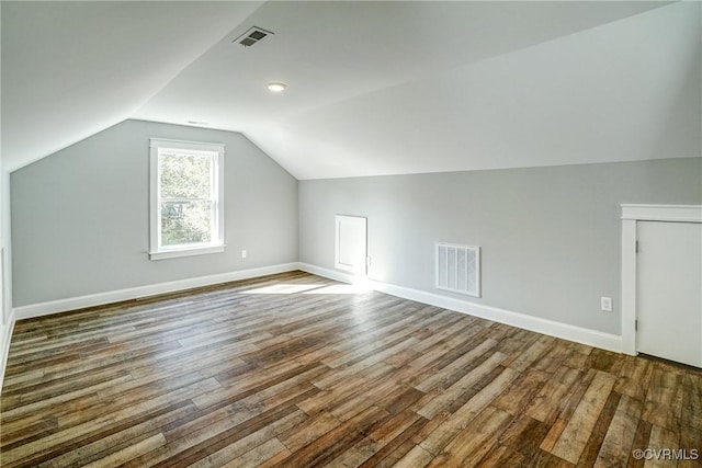 bonus room featuring vaulted ceiling and hardwood / wood-style flooring