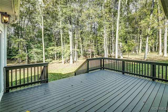 wooden terrace featuring a yard