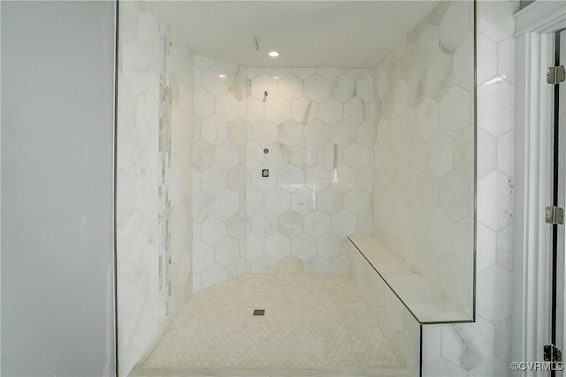 bathroom with tiled shower