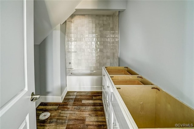 bathroom with vanity, bathing tub / shower combination, and hardwood / wood-style floors