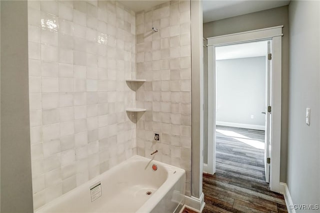 bathroom featuring tiled shower / bath and wood-type flooring