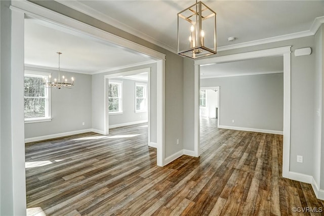 unfurnished dining area featuring a notable chandelier, dark hardwood / wood-style flooring, and ornamental molding