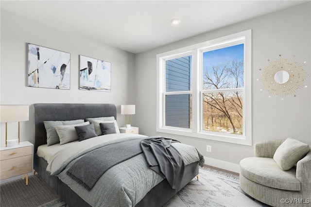 bedroom with wood-type flooring and multiple windows