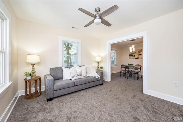 living room featuring carpet floors and ceiling fan