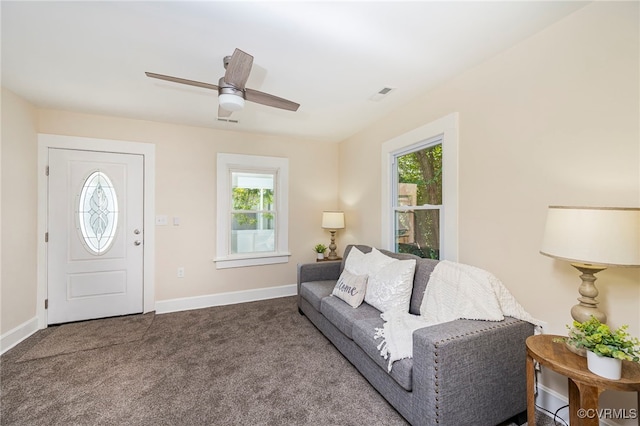 carpeted living room featuring ceiling fan