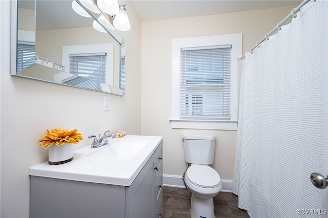 bathroom featuring hardwood / wood-style floors, vanity, and toilet