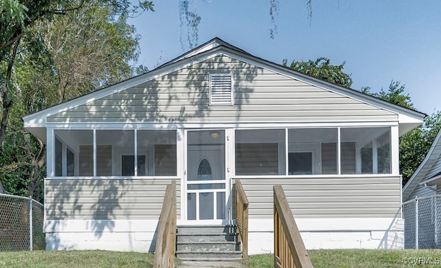 view of front of property featuring a sunroom