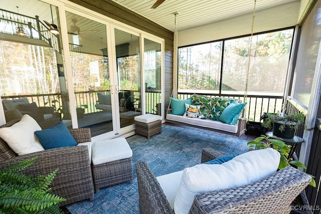 sunroom featuring ceiling fan