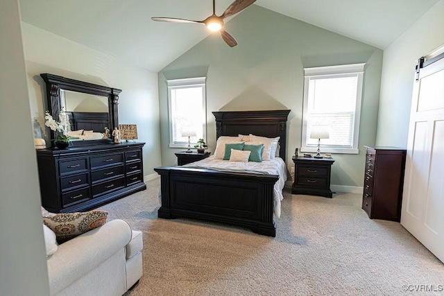 carpeted bedroom with vaulted ceiling, ceiling fan, and a barn door