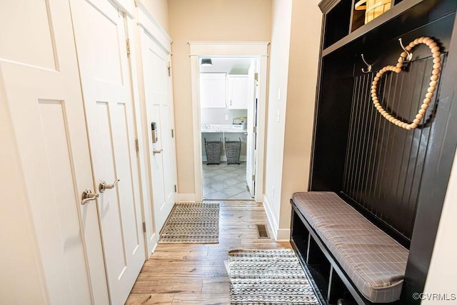 mudroom with light hardwood / wood-style flooring