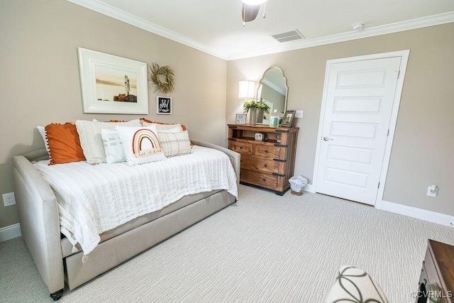 carpeted bedroom with ceiling fan and ornamental molding