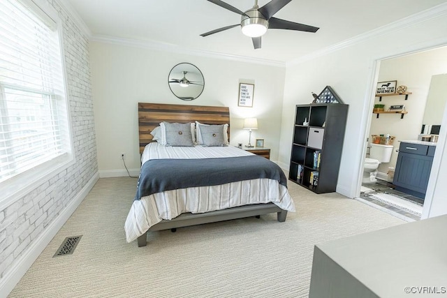 bedroom featuring ceiling fan, light colored carpet, connected bathroom, and ornamental molding