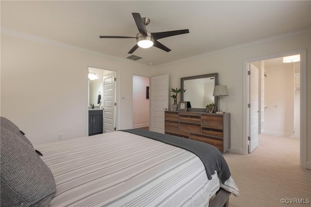 carpeted bedroom featuring crown molding, ceiling fan, and ensuite bath