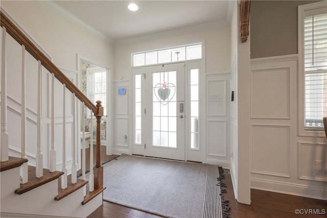 foyer entrance featuring crown molding and dark wood-type flooring