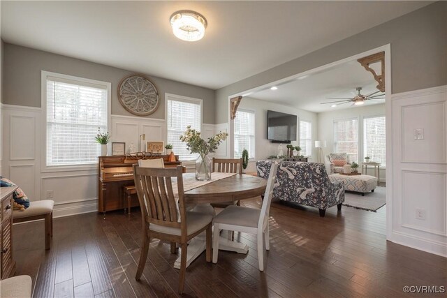 dining space featuring dark wood-type flooring, ceiling fan, and a healthy amount of sunlight