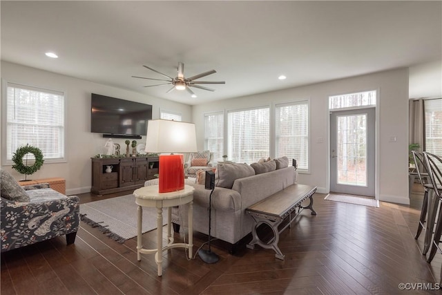 living room featuring plenty of natural light and ceiling fan