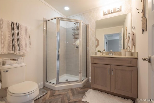 bathroom with parquet floors, ornamental molding, vanity, toilet, and a shower with door