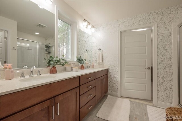 12618 Capernwray Ter, Chesterfield, VA 23838 - full bath with double vanity, a stall shower, wallpapered walls, wood finished floors, and baseboards