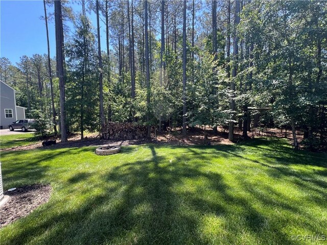 12618 Capernwray Ter, Chesterfield, VA 23838 - view of grassy yard with a fire pit