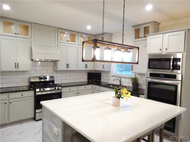 kitchen featuring custom exhaust hood, decorative light fixtures, stainless steel appliances, a breakfast bar, and white cabinetry