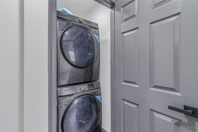 washroom featuring stacked washer and dryer