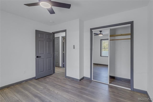 unfurnished bedroom featuring ceiling fan, a closet, and hardwood / wood-style flooring