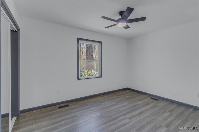 spare room featuring ceiling fan and hardwood / wood-style flooring