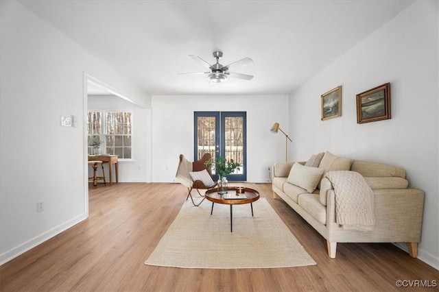 living room featuring ceiling fan, french doors, and hardwood / wood-style flooring