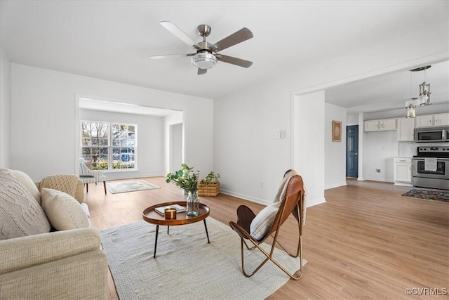 living room featuring light wood-type flooring and ceiling fan