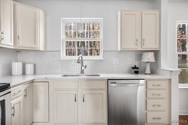 kitchen with sink, dishwasher, decorative light fixtures, and decorative backsplash