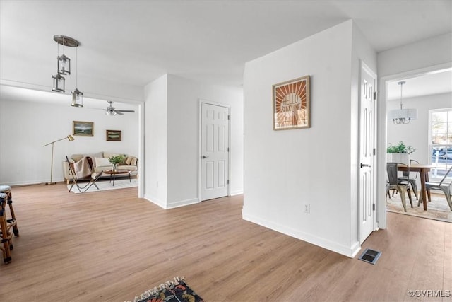 interior space with light hardwood / wood-style floors and a chandelier