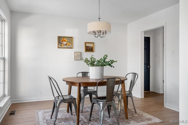 dining area featuring a wealth of natural light and dark wood-type flooring