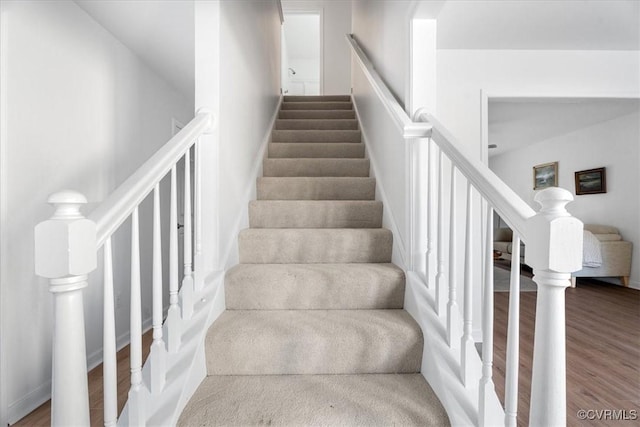 stairs featuring hardwood / wood-style flooring