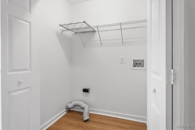 clothes washing area with electric dryer hookup, hookup for a washing machine, and wood-type flooring