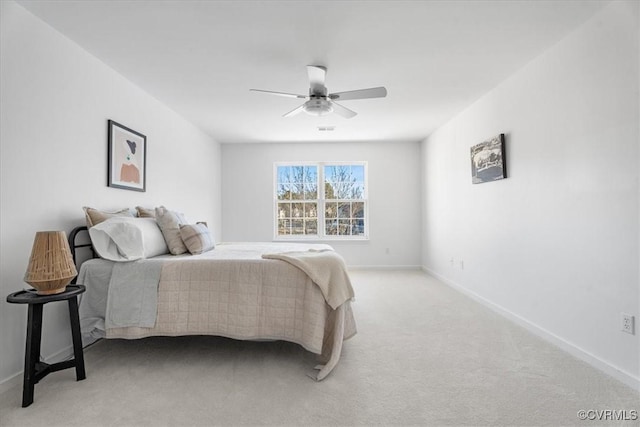 bedroom featuring light colored carpet and ceiling fan