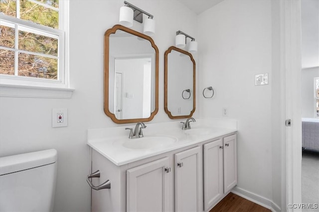 bathroom featuring toilet and vanity